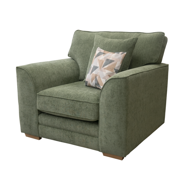 Green armchair with a patterned pillow on a white background