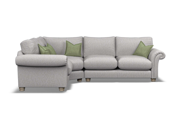 Gray sectional sofa with green cushions on a white background