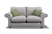 Gray sofa with green cushions on a white background